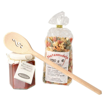 Gift set with music note pasta, treble clef wooden spoon and pasta sauce in carrying bag