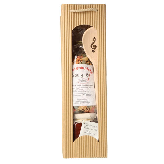 Gift set with music note pasta, treble clef wooden spoon and pasta sauce in carrying bag