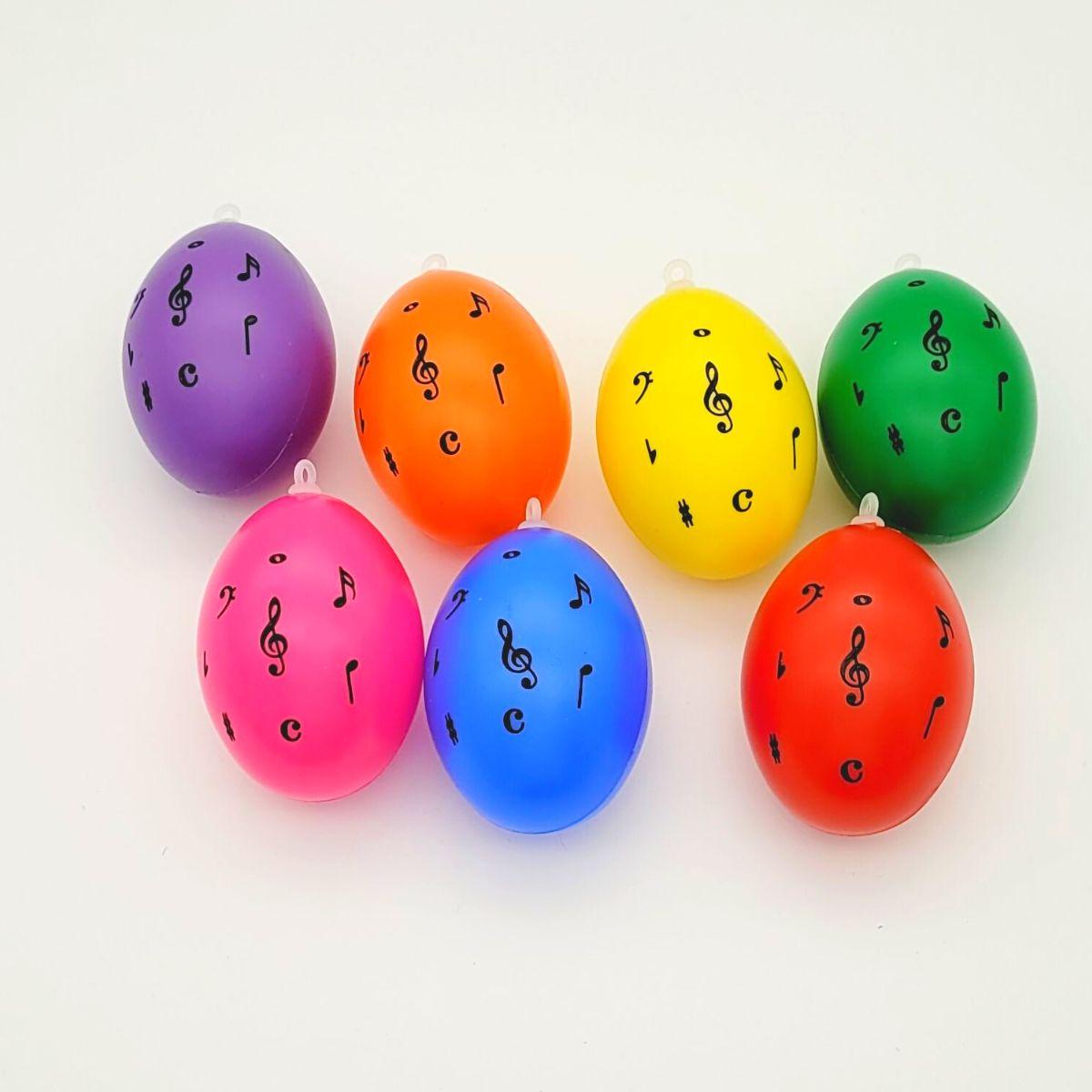 Set of 7 decorative Easter eggs with treble clef and notes, various colors