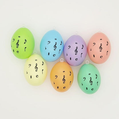 Set of 7 decorative Easter eggs with treble clef and notes, various colors