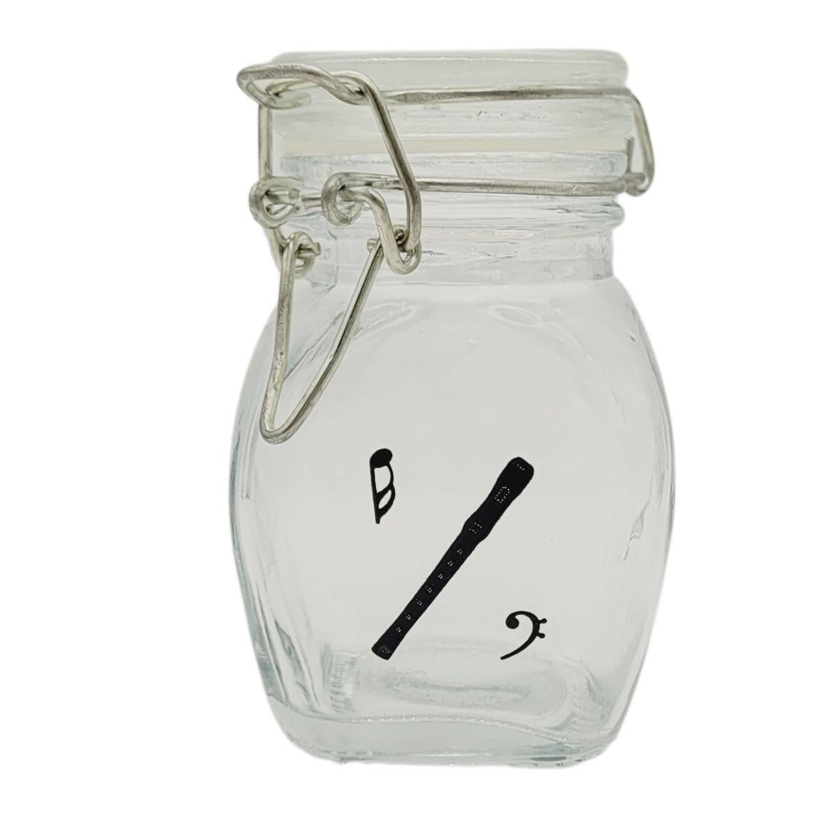 Mini storage jar with various instruments in black