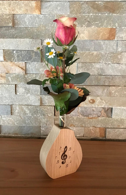 Noble wooden vase including glass cylinder with treble clef and notes