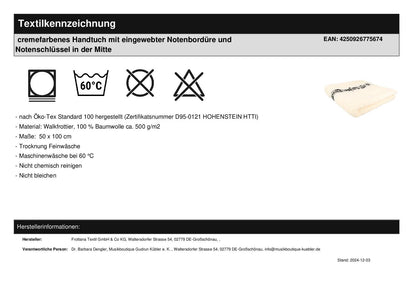 cremefarbenes Handtuch mit eingewebter Notenbordüre und Notenschlüssel in der Mitte