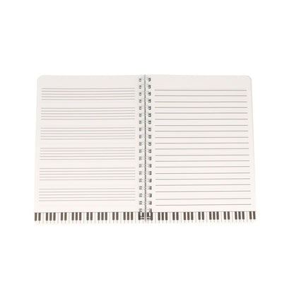 black spiral notebook with white music lines